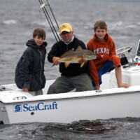 captain Jeff shows off a redfish the boys caught in Panama City beach