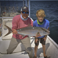 captain Giles and angler with a Amberjack on his blazer bay boat captain Giles and angler with a Amberjack on his blazer bay boat