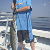 young angler with a big Spanish mackerel off seaside Florida young angler with a big Spanish mackerel off seaside Florida