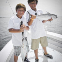 couple proud young anglers display their catch of bonito off Panama City couple proud young anglers display their catch of bonito off Panama City